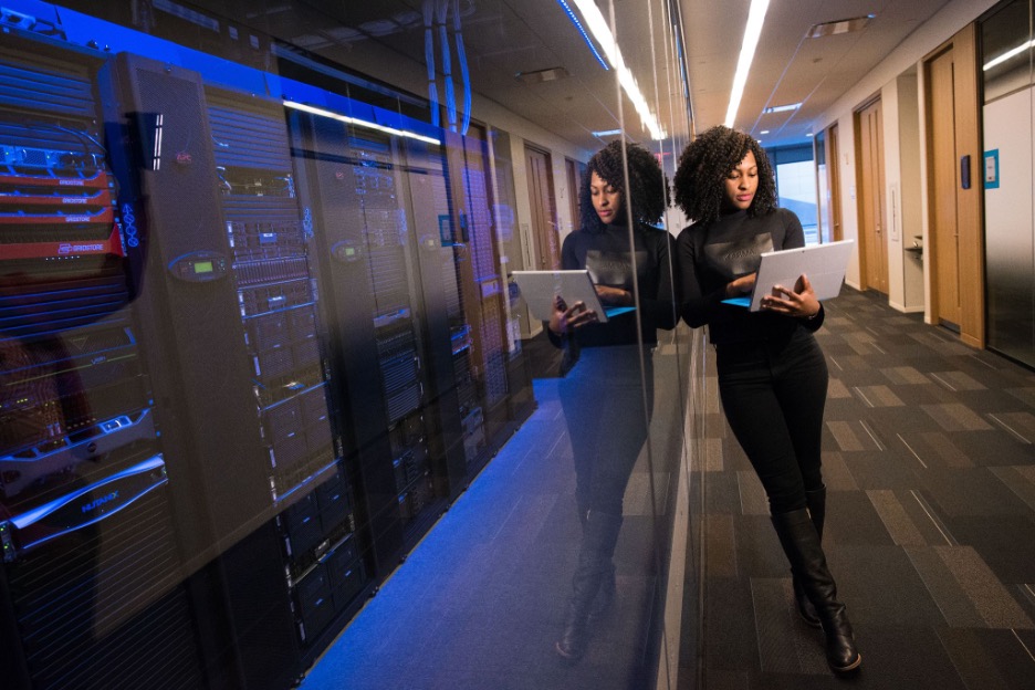 woman with a laptop at a data center identifying key digital trends